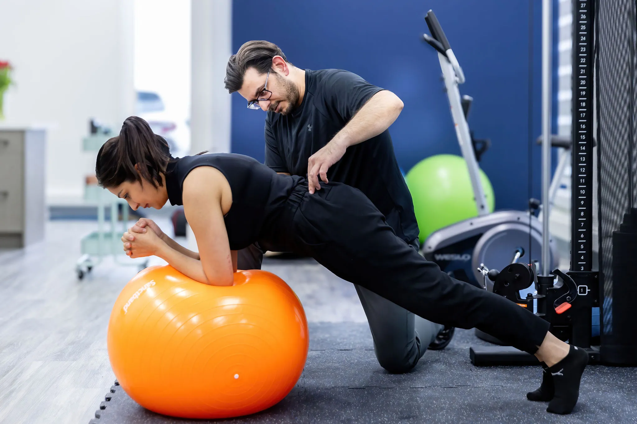 Physiotherapist guiding a core stability exercise at Physio Studio Health